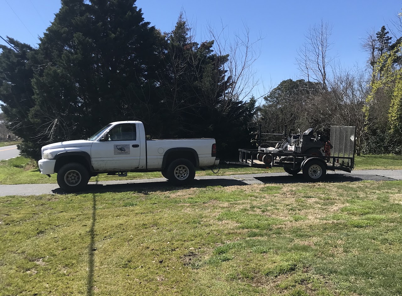 Ranger Lawn Care's truck and trailer loaded with lawn care equipment